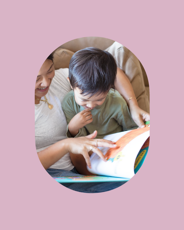 Karen Chan and Son reading a -picture book together on a couch